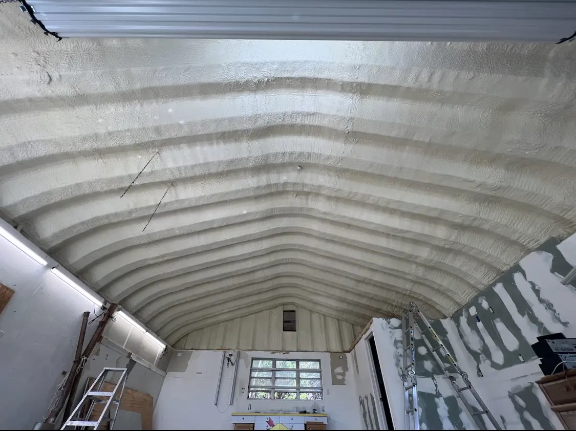 Spray polyurethane foam applied to the underside of a metal roof deck in Crystal City
